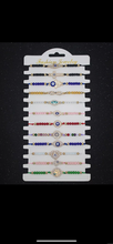 Load image into Gallery viewer, 12 pieces of multicolor evil eye bracelets.