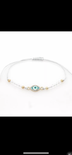 Load image into Gallery viewer, 12 pieces of multicolor evil eye bracelets.